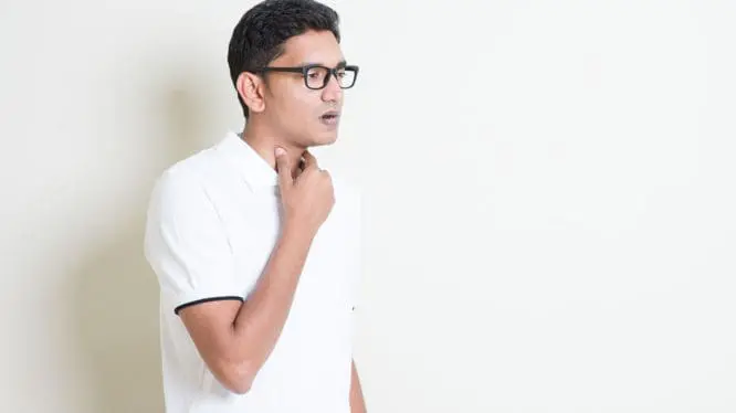 Man holding throat due to hoarseness
