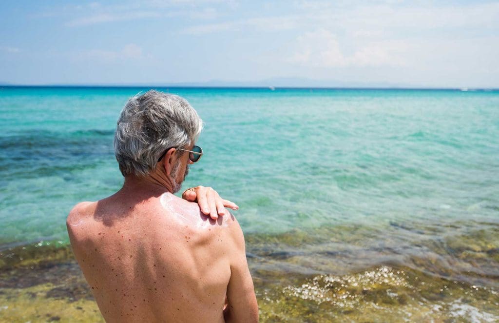 Man applying sun screen