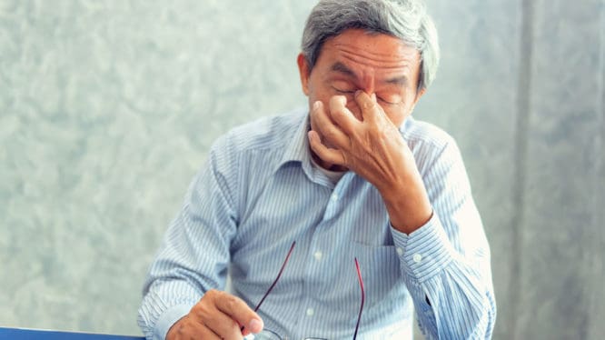 Older gentleman suffering from sinus headache